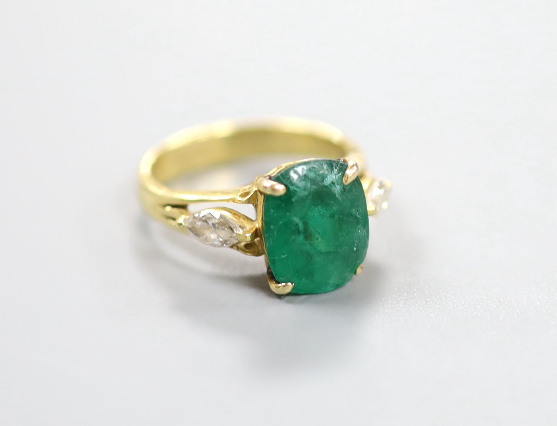 A yellow metal, emerald and diamond three stone ring, size M, gross weight 5.3 grams.